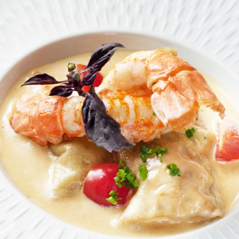 Elegant shrimp in light broth with fresh garnishes